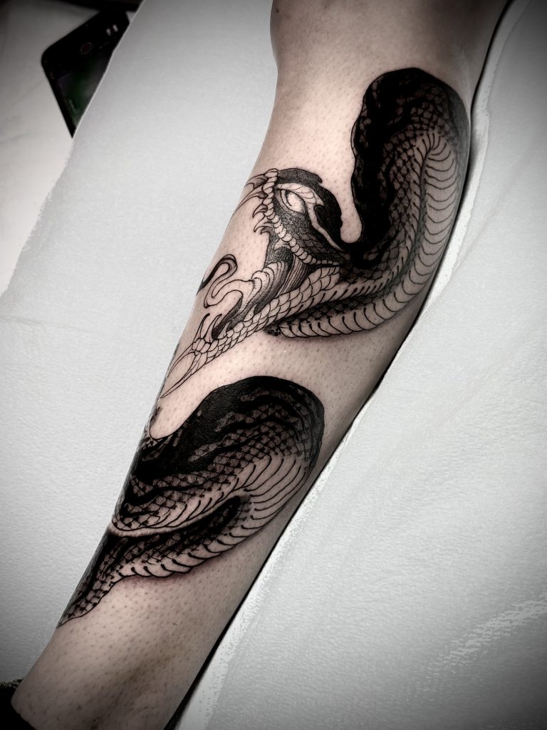 Black and grey snake tattoo