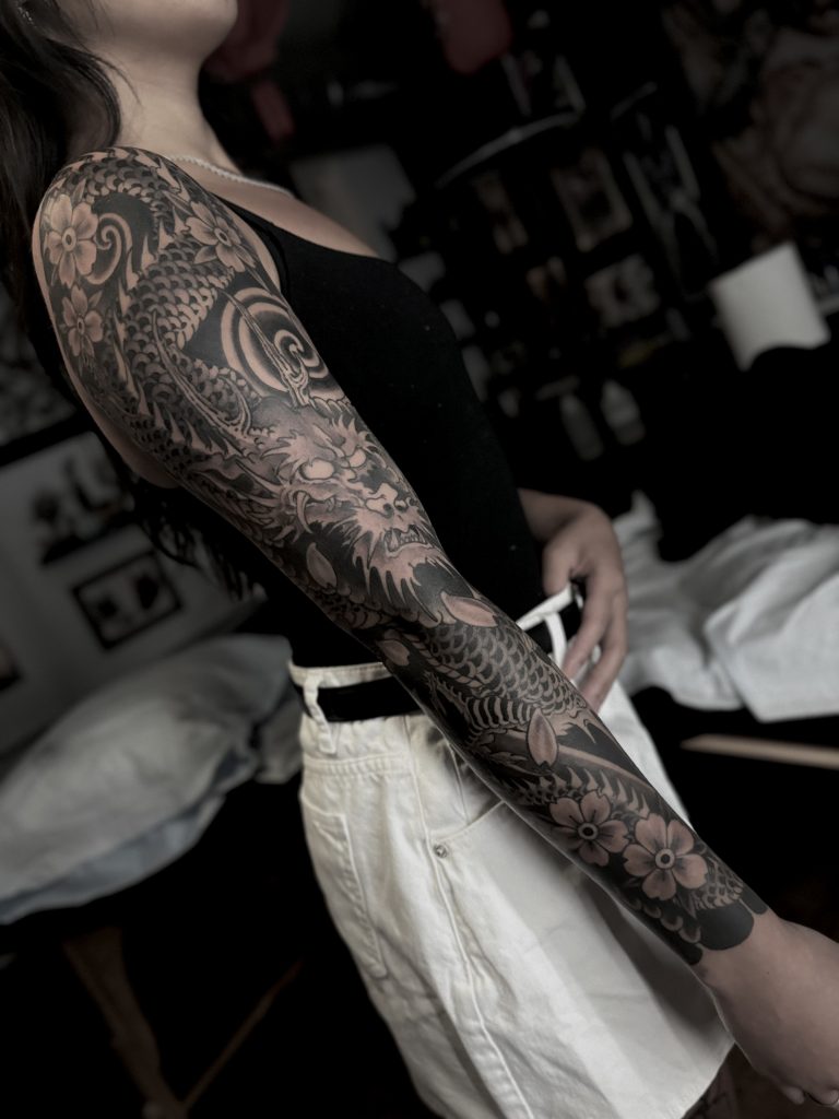 Black and grey dragon full arm tattoo sleeve